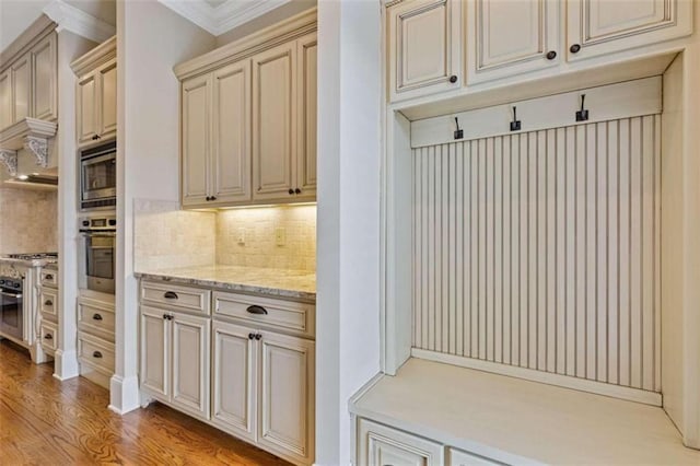 mudroom featuring light hardwood / wood-style flooring and crown molding