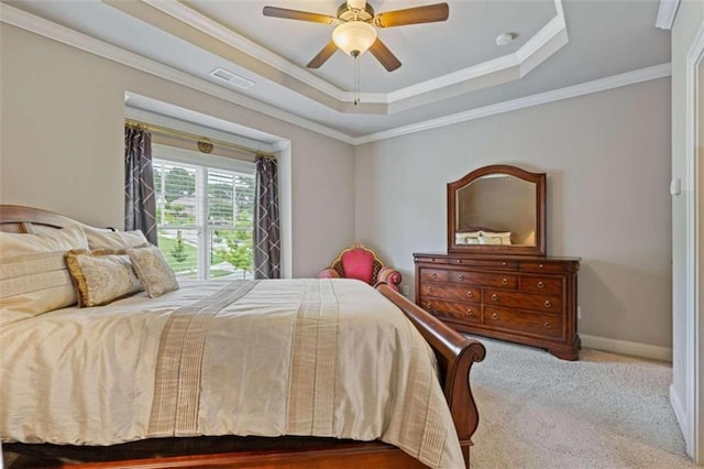 bedroom with a raised ceiling, carpet flooring, ornamental molding, and ceiling fan