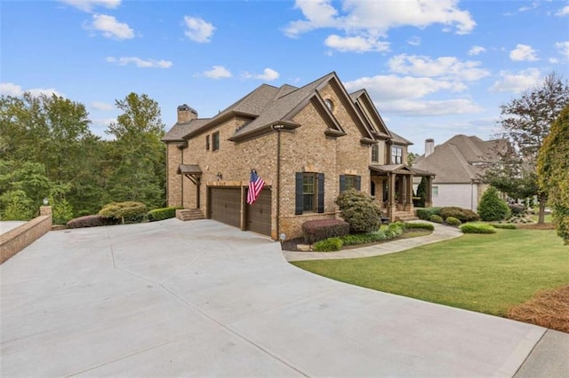 view of side of property with a lawn and a garage