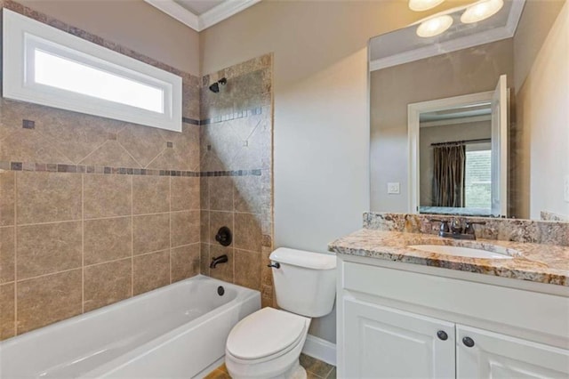 full bathroom featuring tiled shower / bath, vanity, crown molding, and toilet