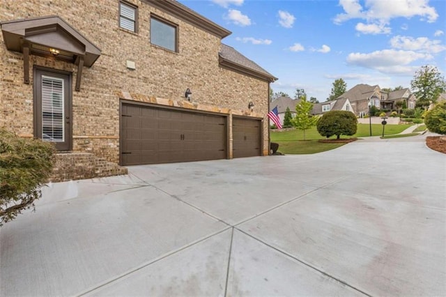 view of property exterior with a garage and a yard