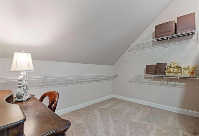 spacious closet featuring vaulted ceiling and carpet flooring