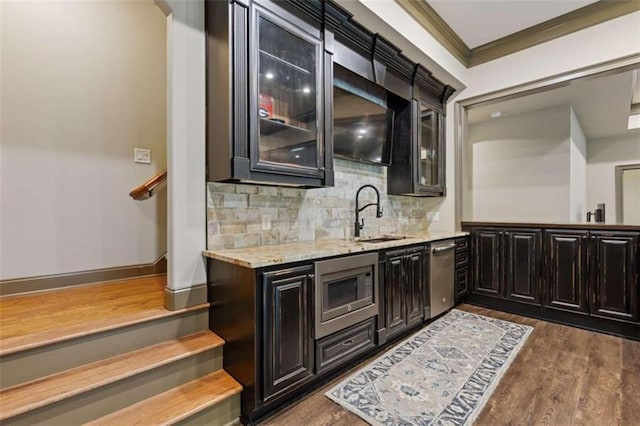 bar with dark hardwood / wood-style flooring, appliances with stainless steel finishes, crown molding, and sink