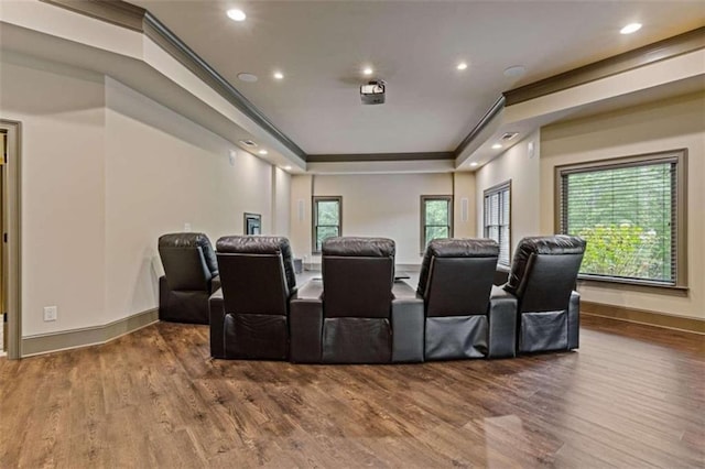 home theater room featuring hardwood / wood-style flooring and ornamental molding