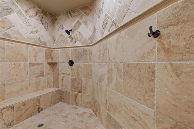 bathroom with tiled shower