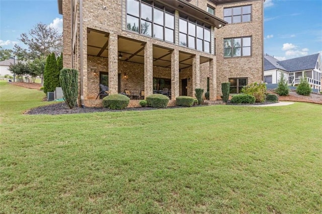 exterior space featuring a yard and central AC