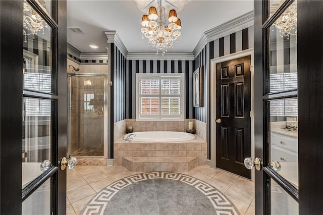 306 Calumet Ln, Monroe, GA 30655 - full bath featuring tile patterned floors, crown molding, a chandelier, a garden tub, and a stall shower