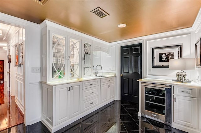 306 Calumet Ln, Monroe, GA 30655 - indoor wet bar with beverage cooler, granite tiled floors, recessed lighting, and ornamental molding