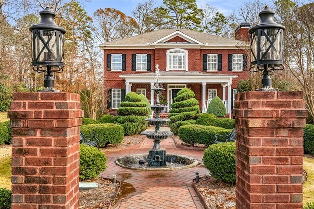 306 Calumet Ln, Monroe, GA 30655 - view of front of home featuring brick siding and a chimney