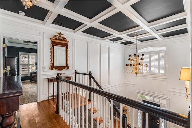 306 Calumet Ln, Monroe, GA 30655 - hall featuring a decorative wall, a chandelier, dark wood-style flooring, beamed ceiling, and coffered ceiling