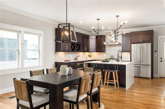 1354 Mcpherson Ave SE, Atlanta, GA 30316 - dining room with a chandelier, light wood-style floors, ornamental molding, and recessed lighting