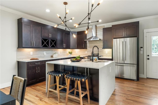 1354 Mcpherson Ave SE, Atlanta, GA 30316 - kitchen with high end refrigerator, wall chimney exhaust hood, light countertops, tasteful backsplash, and a chandelier