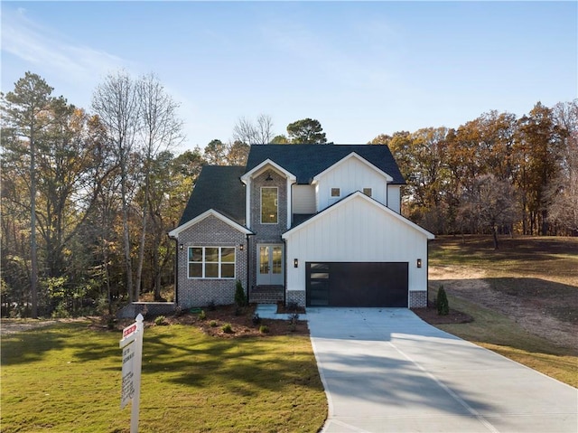 modern inspired farmhouse with a front yard and a garage