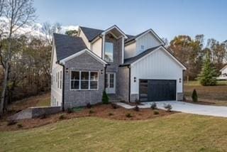 view of front of property with a garage and a front lawn