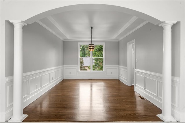 unfurnished dining area with dark wood-style flooring, visible vents, crown molding, and wainscoting