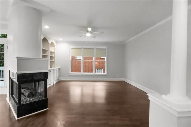unfurnished living room featuring a healthy amount of sunlight, a multi sided fireplace, wood finished floors, and a ceiling fan