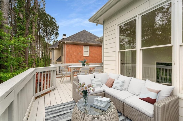 wooden terrace with outdoor lounge area and outdoor dining area