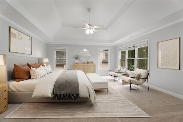 bedroom featuring carpet floors, ornamental molding, a tray ceiling, and baseboards