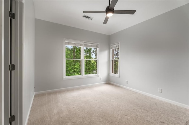 unfurnished room featuring carpet floors, visible vents, and baseboards