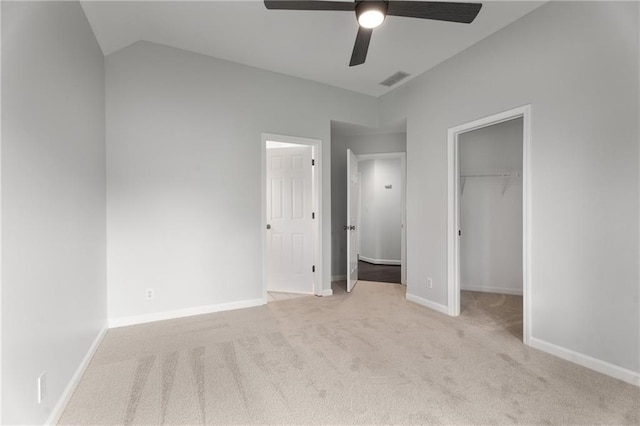unfurnished bedroom featuring ceiling fan, visible vents, a closet, carpet, and a spacious closet