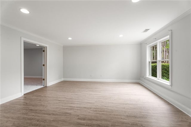 spare room featuring ornamental molding, recessed lighting, and wood finished floors