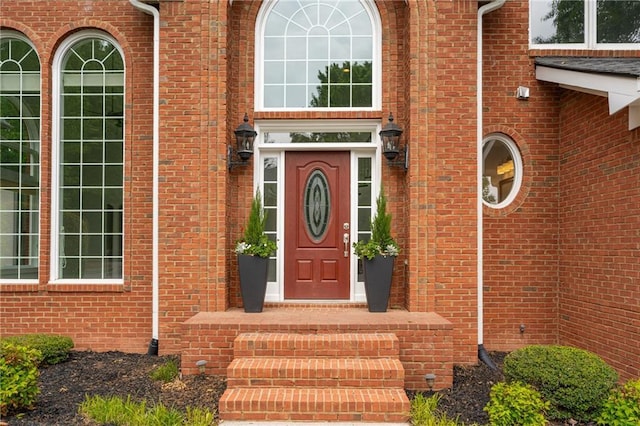 entrance to property with brick siding