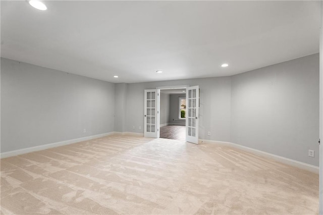 unfurnished room featuring french doors, recessed lighting, baseboards, and light carpet