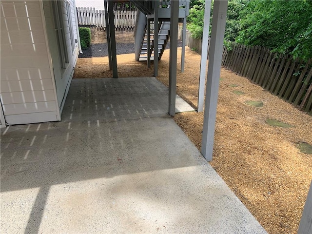 view of patio featuring stairway and a fenced backyard
