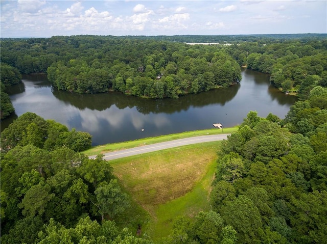 aerial view with a wooded view and a water view