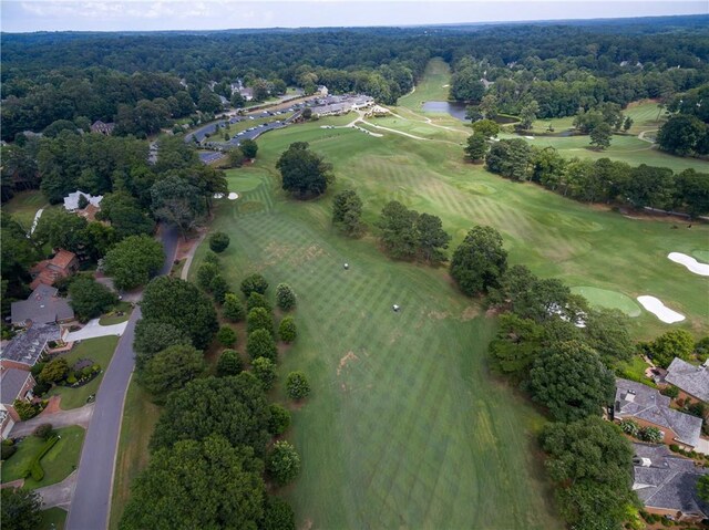 drone / aerial view featuring golf course view and a water view