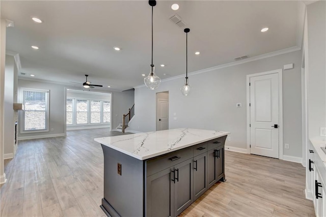 kitchen featuring hanging light fixtures, crown molding, light hardwood / wood-style flooring, and ceiling fan