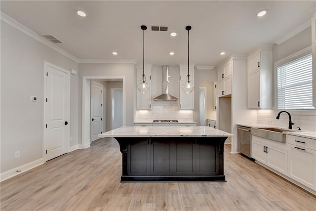 kitchen with light stone countertops, wall chimney range hood, a center island, and dishwasher