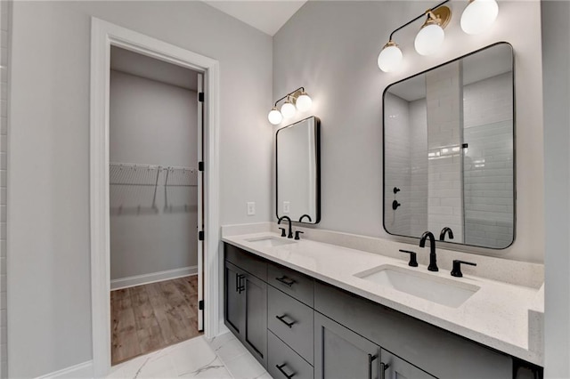 bathroom featuring hardwood / wood-style floors, vanity, and a shower