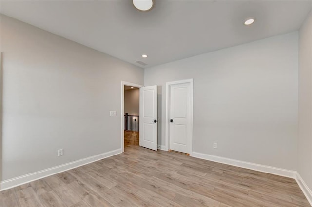 unfurnished room with light wood-type flooring