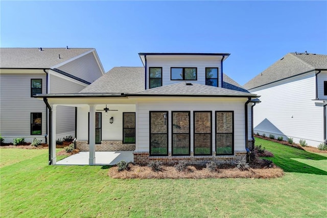 rear view of property featuring a patio and a lawn