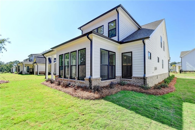 view of home's exterior with a lawn