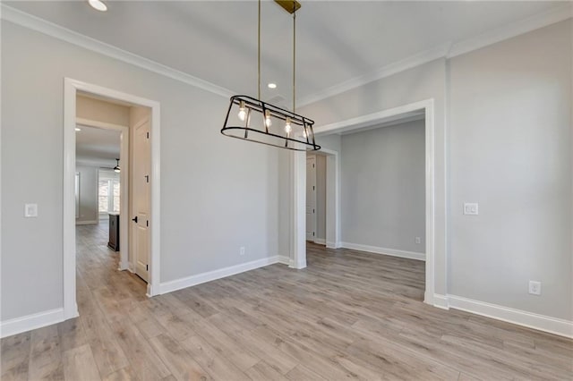 unfurnished dining area with light wood-type flooring and ornamental molding