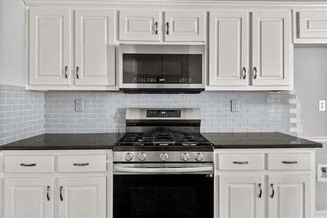 93 Pebble Creek Dr, Newnan, GA 30265 - kitchen with stainless steel appliances, dark countertops, decorative backsplash, and white cabinetry