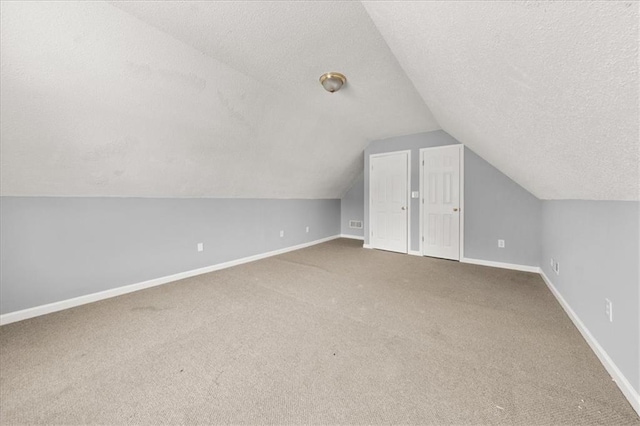 93 Pebble Creek Dr, Newnan, GA 30265 - bonus room featuring a textured ceiling, carpet flooring, and vaulted ceiling