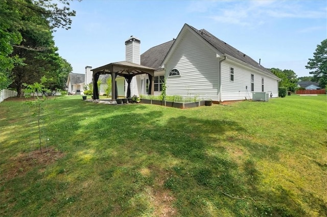 93 Pebble Creek Dr, Newnan, GA 30265 - back of house featuring a gazebo, a lawn, and a chimney