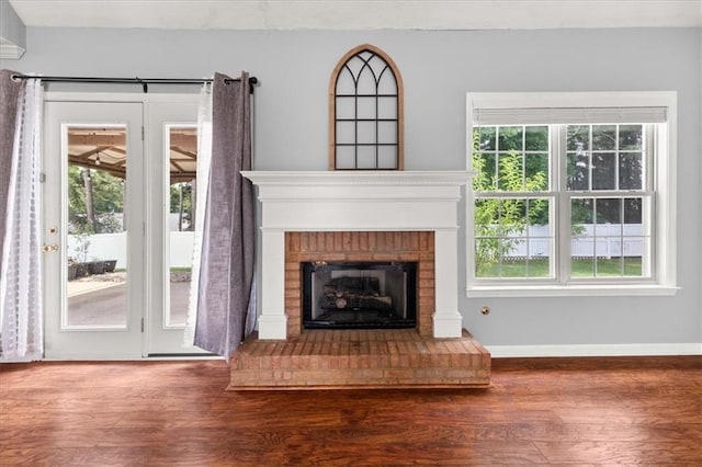 93 Pebble Creek Dr, Newnan, GA 30265 - unfurnished living room featuring wood finished floors and a brick fireplace