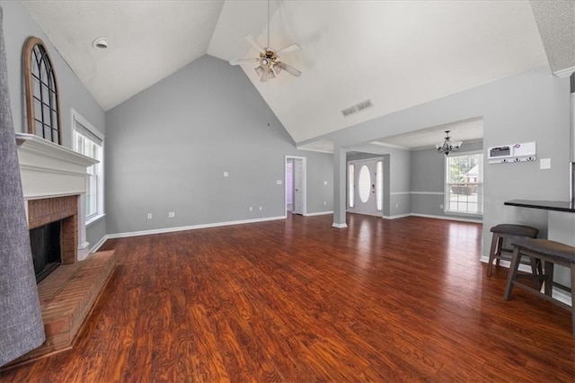 93 Pebble Creek Dr, Newnan, GA 30265 - unfurnished living room with a chandelier, ceiling fan, wood finished floors, a fireplace, and high vaulted ceiling