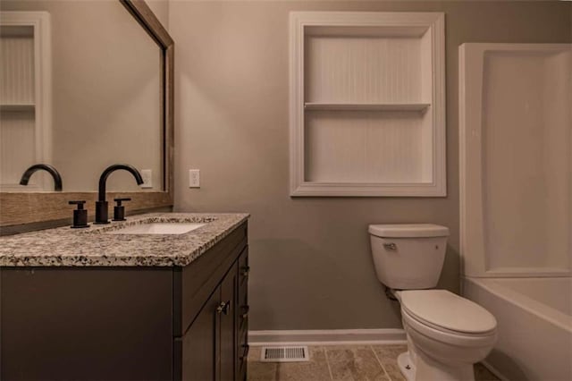 bathroom featuring vanity, toilet, and tile patterned floors