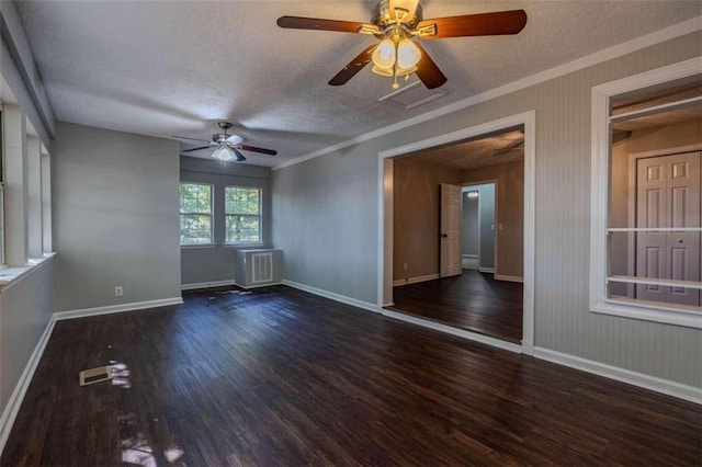 empty room featuring a textured ceiling, ornamental molding, dark hardwood / wood-style floors, and ceiling fan