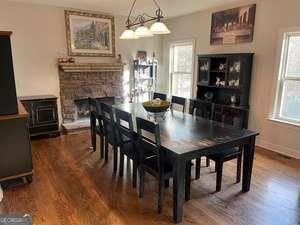 dining space featuring hardwood / wood-style flooring and a fireplace