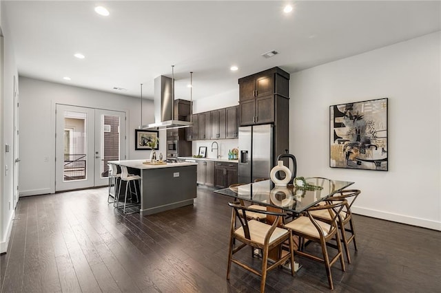 dining space featuring dark hardwood / wood-style flooring, french doors, and sink