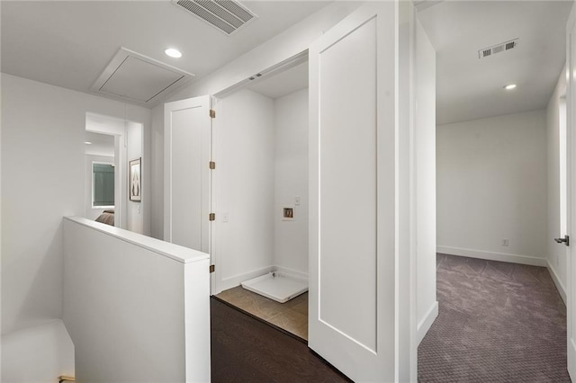 hallway with dark colored carpet