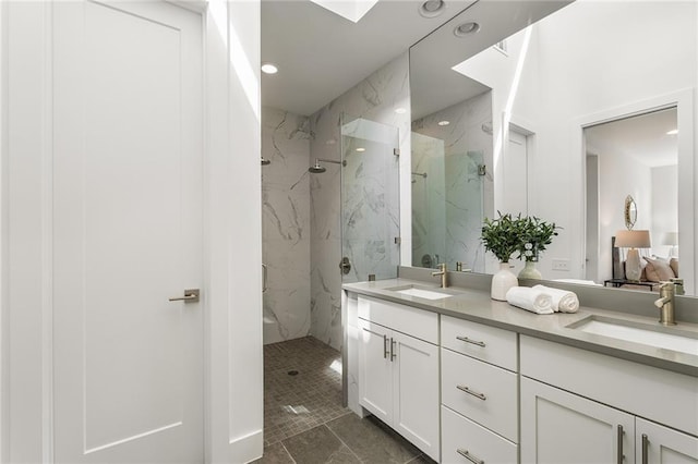 bathroom with vanity and tiled shower