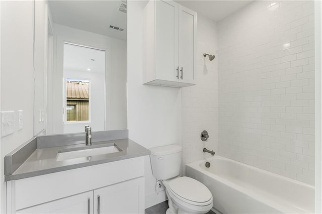 full bathroom with vanity, toilet, and tiled shower / bath