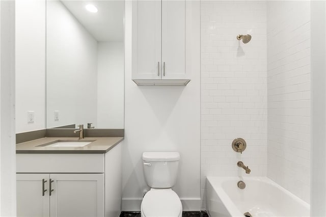 full bathroom with vanity, tiled shower / bath, and toilet